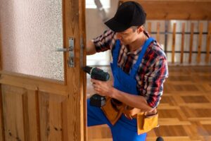 handyman repair the door lock in the room